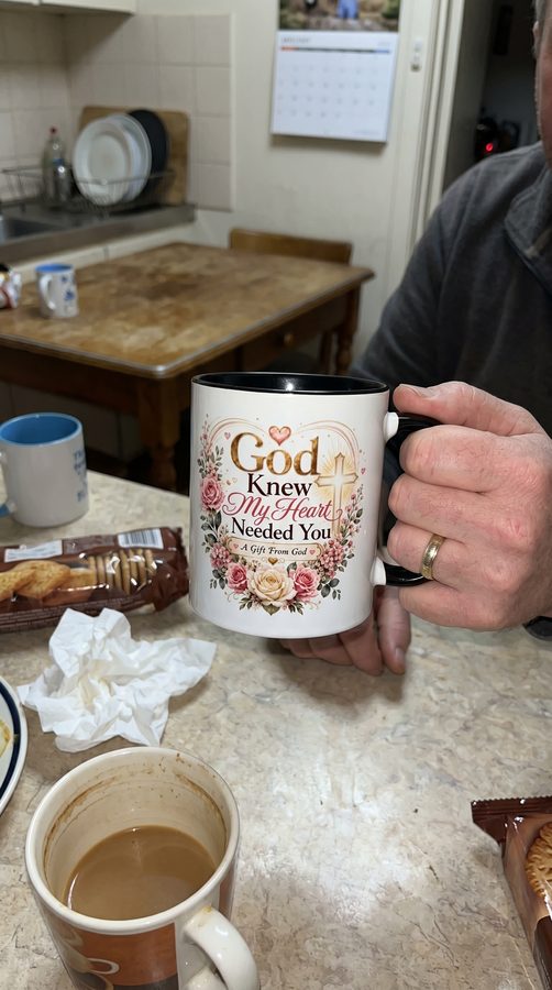 Customer holding the black interior God Knew My Heart Needed You mug